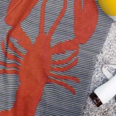 serviette de plage homard posée sur le sable